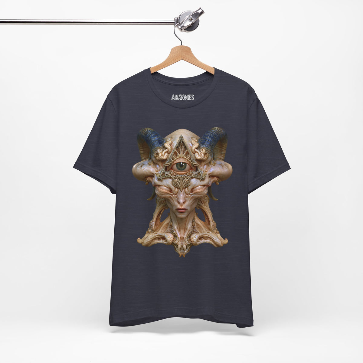 Hanging front view of The Unseen Order T-Shirt in Heather Midnight Navy, featuring an ivory otherworldly face with a green forehead eye and blue horns.