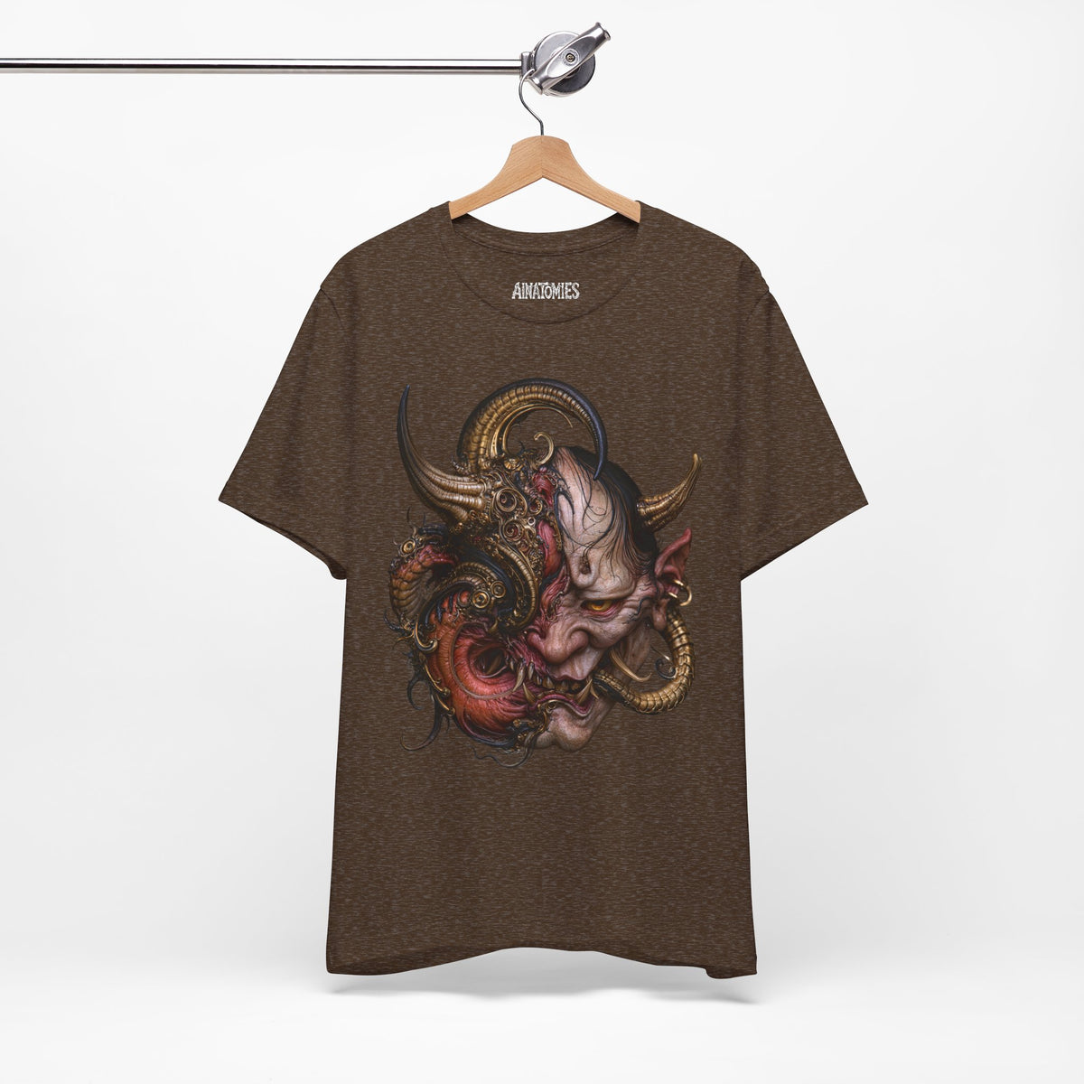 Hanging front view of The Hunger Beneath T-Shirt in Heather Brown, featuring a horned creature in pink, red and gold.