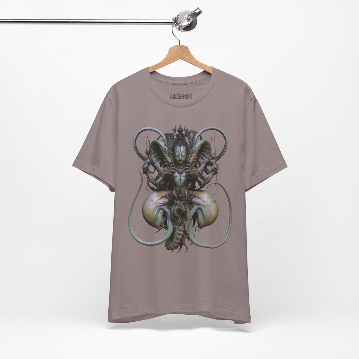 Hanging front view of The Thread That Holds T-Shirt in Pebble Brown, featuring an ornate guardian portrait with green, blue and ivory curls.