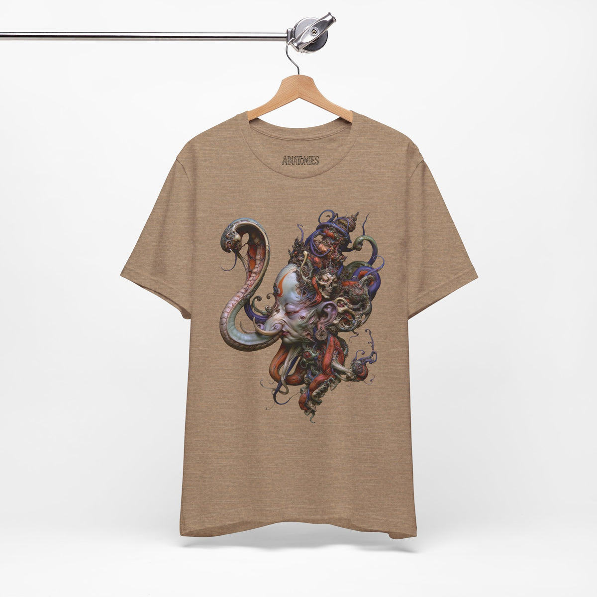 Hanging front view of The Eternal Accord T-Shirt in Heather Tan, featuring a richly ornamented figure surrounded by coiling organic forms.
