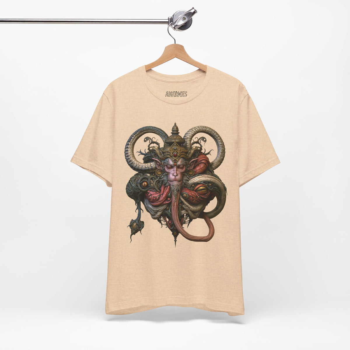 Hanging front view of The Weight of a Vow T-Shirt in Heather Sand Dune, featuring a crowned mythic face with curling olive and coral forms.