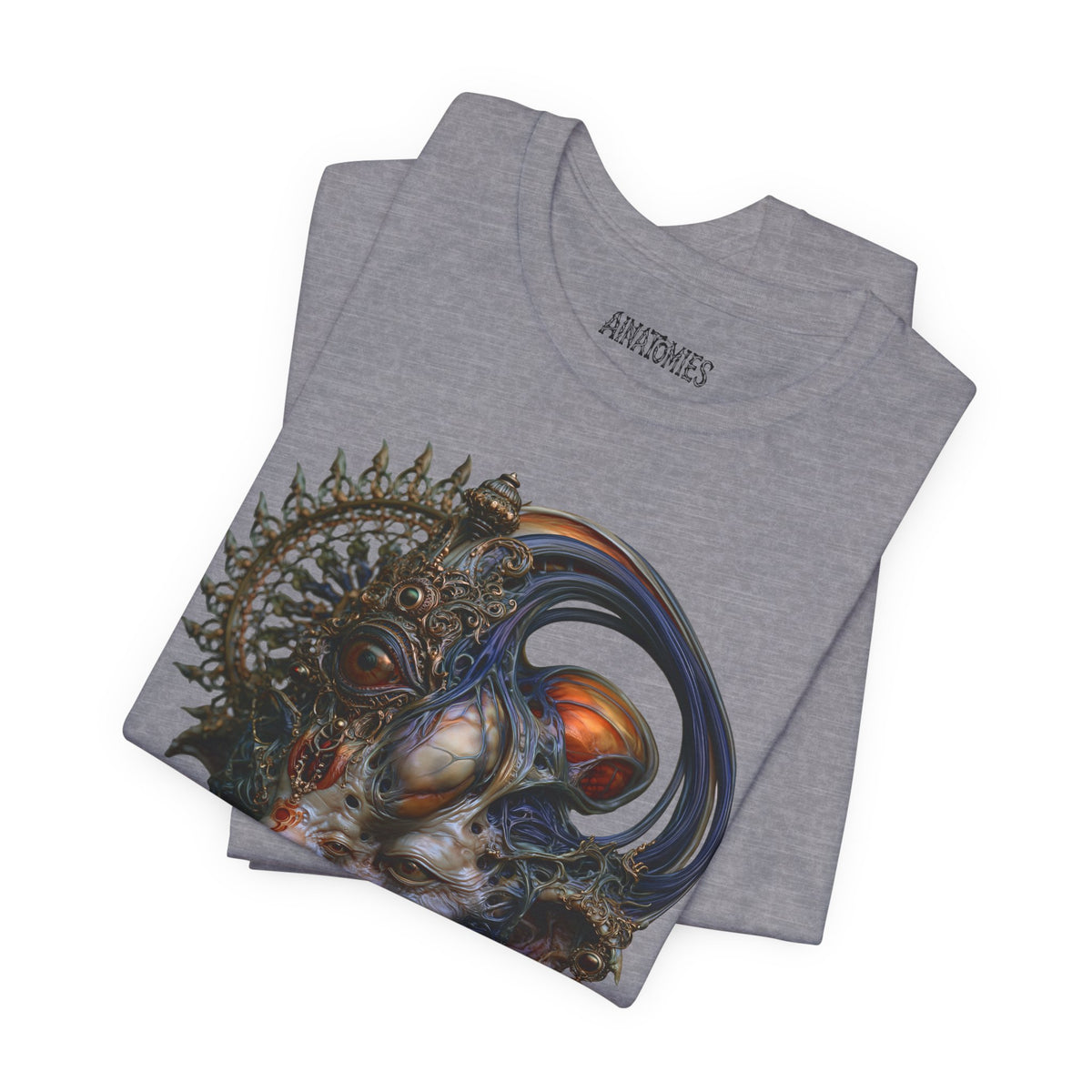 Folded The First Becoming T-Shirt in Heather Storm, showing a close view of a surreal face with blue curves, orange accents and an ornate circular crown.
